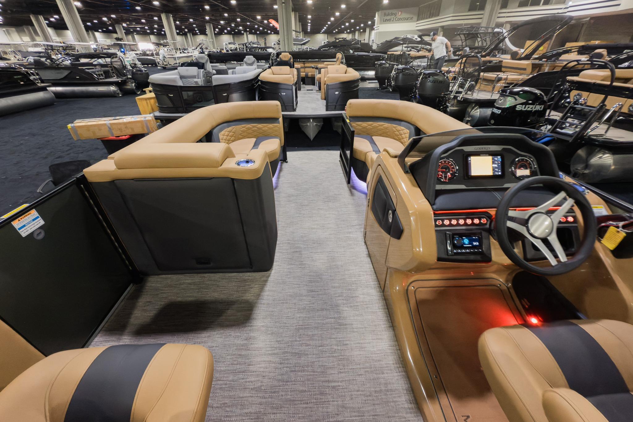 Luxurious 2026 Godfrey Monaco 235 Split Bench boat interior with modern dashboard and seating.