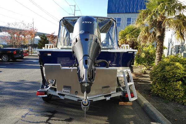2024 Hewescraft 180 Pro-V ET boat with powerful outboard motor, parked outdoors.