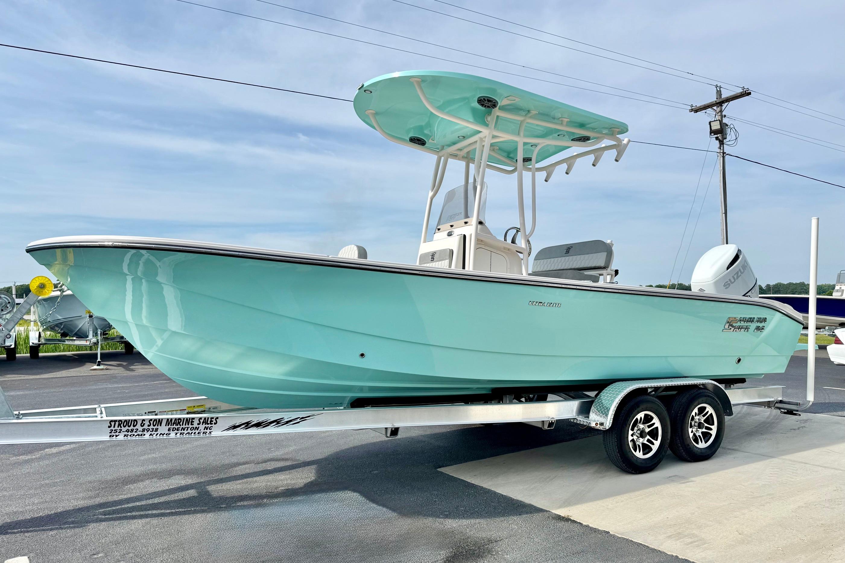 2026 Carolina Skiff 24 Ultra Elite boat on trailer, light blue hull, outdoor display.