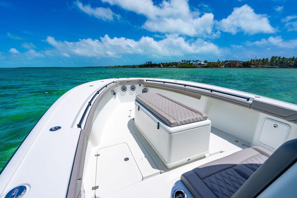 2015 Yellowfin CC boat on clear turquoise water under a bright blue sky.