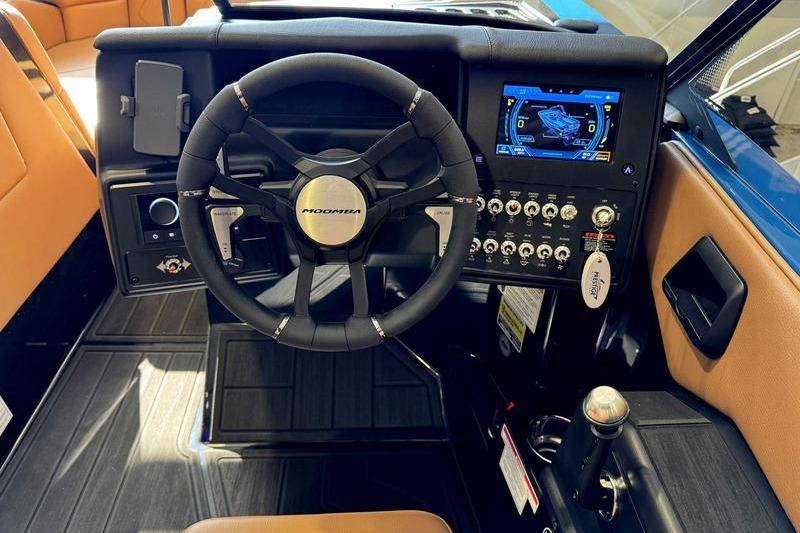 2026 Moomba Tykon boat dashboard with steering wheel and digital display.