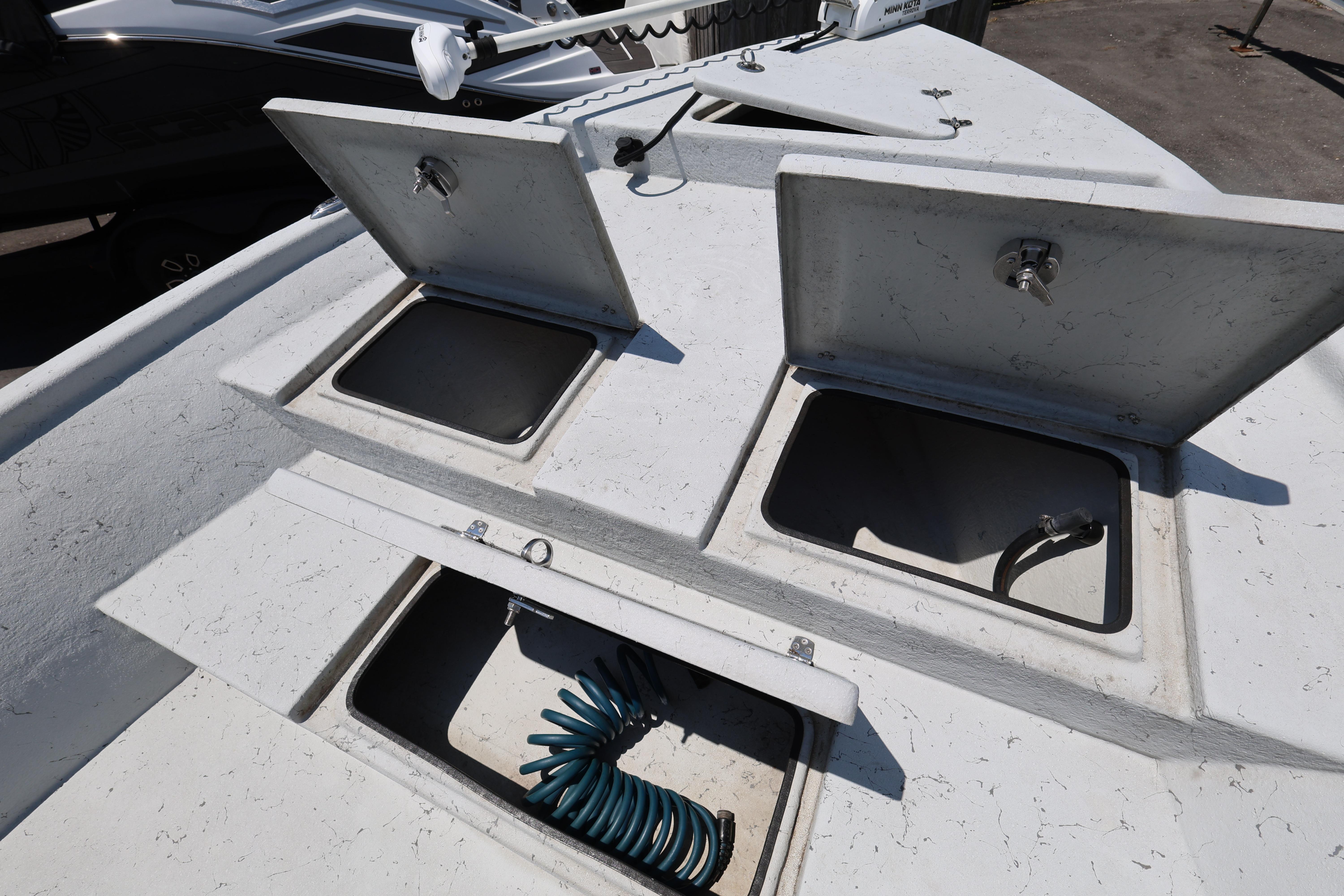 Open storage compartments on a 2021 Blazer Bay 2400 boat deck.