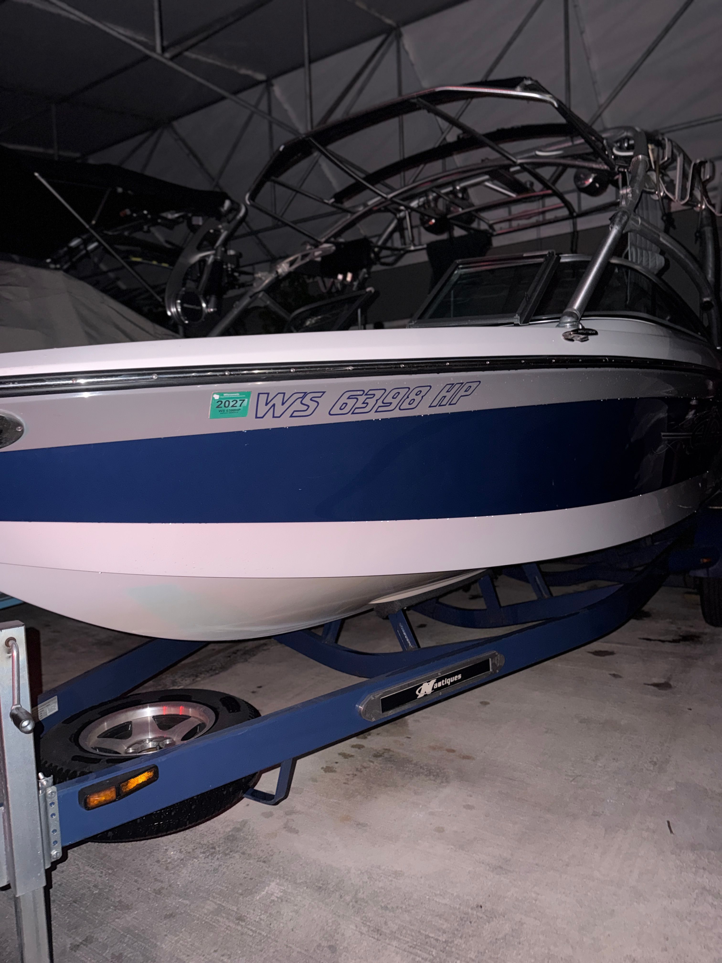 2008 Nautique 236 Team Edition boat on trailer in garage.