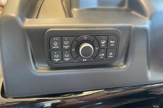 Control panel of 2026 Regency 230 DL boat with various function buttons and a central dial.