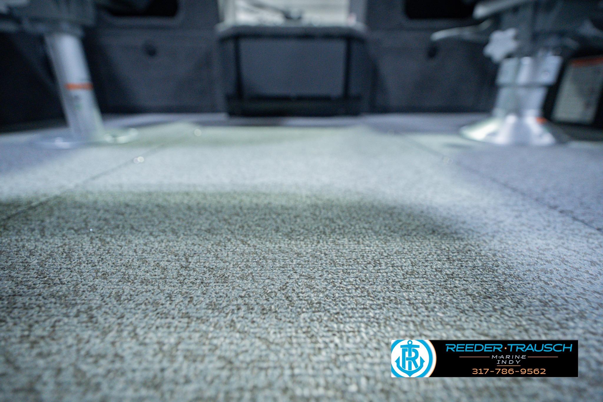 2026 Lund 1775 Impact XS boat interior with carpeted flooring and seating.