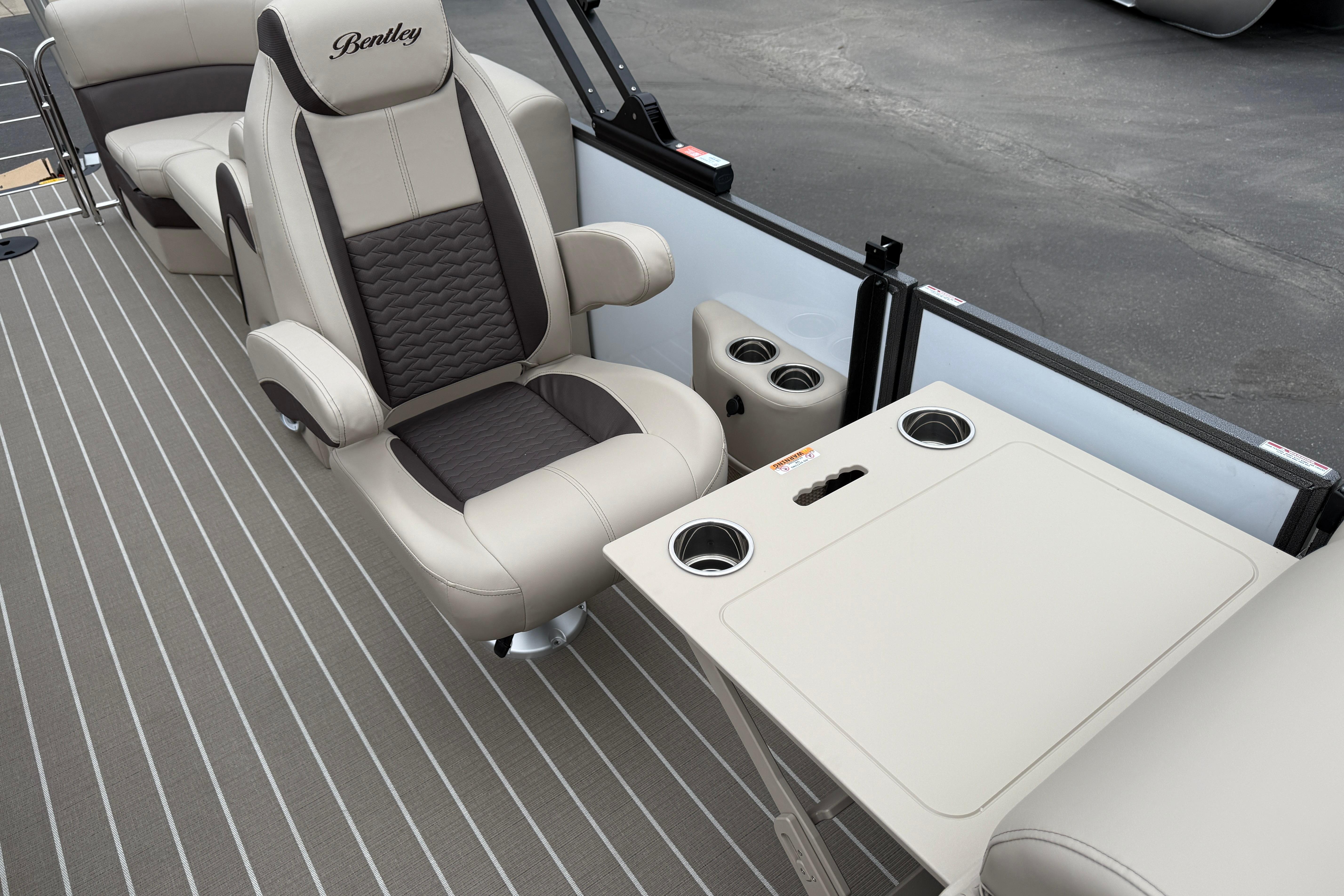 Luxurious interior of 2026 Bentley Pontoons Elite 253 Admiral with plush seating and table.