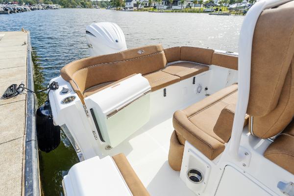 2025 Sea Hunt Ultra 235 SE boat interior with tan seating by the water.