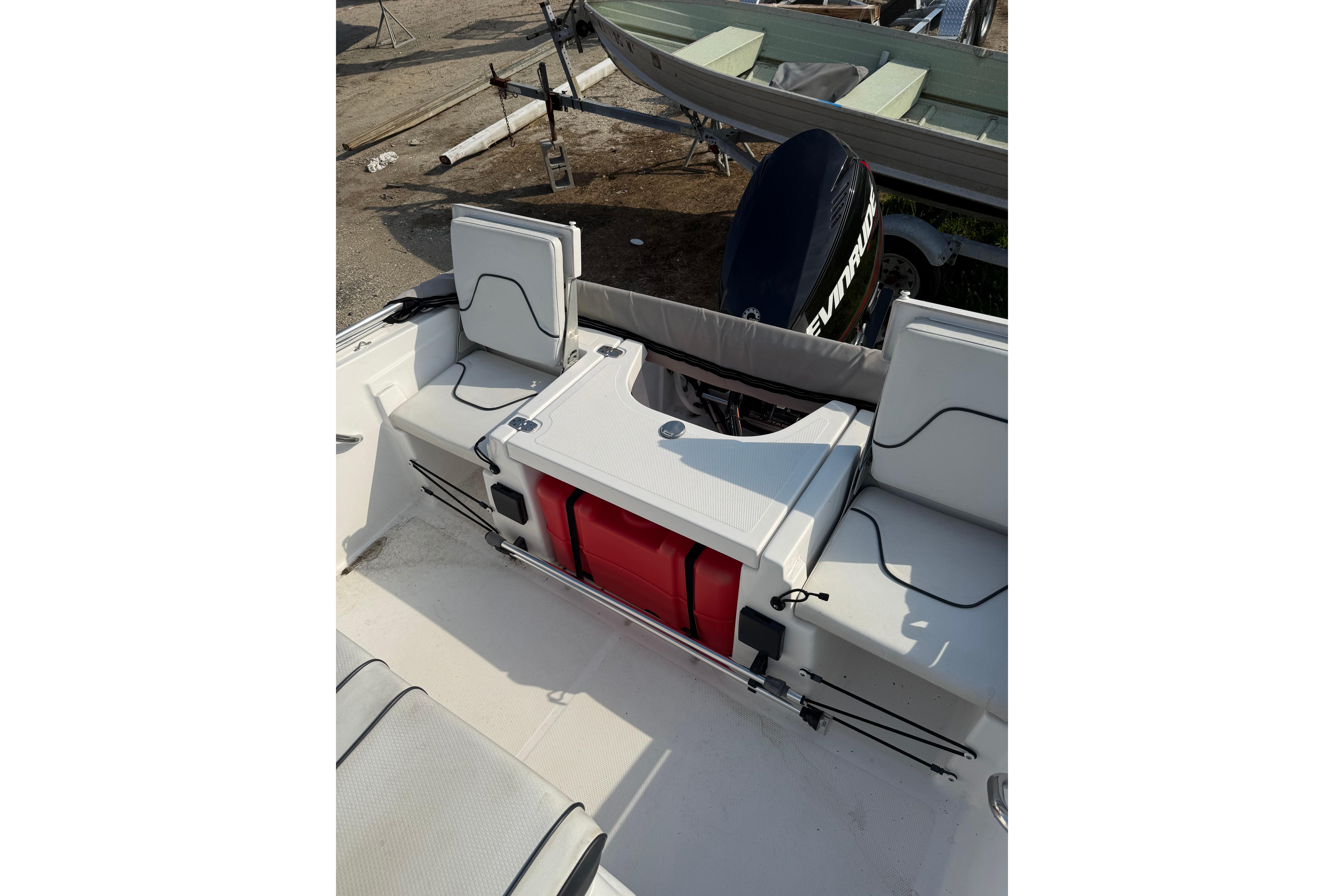 2020 Wellcraft 162 Fisherman boat interior with seating and Evinrude outboard motor.