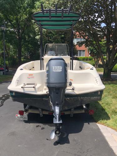 2003 Wellcraft 180 Fisherman boat with outboard motor, parked on driveway.