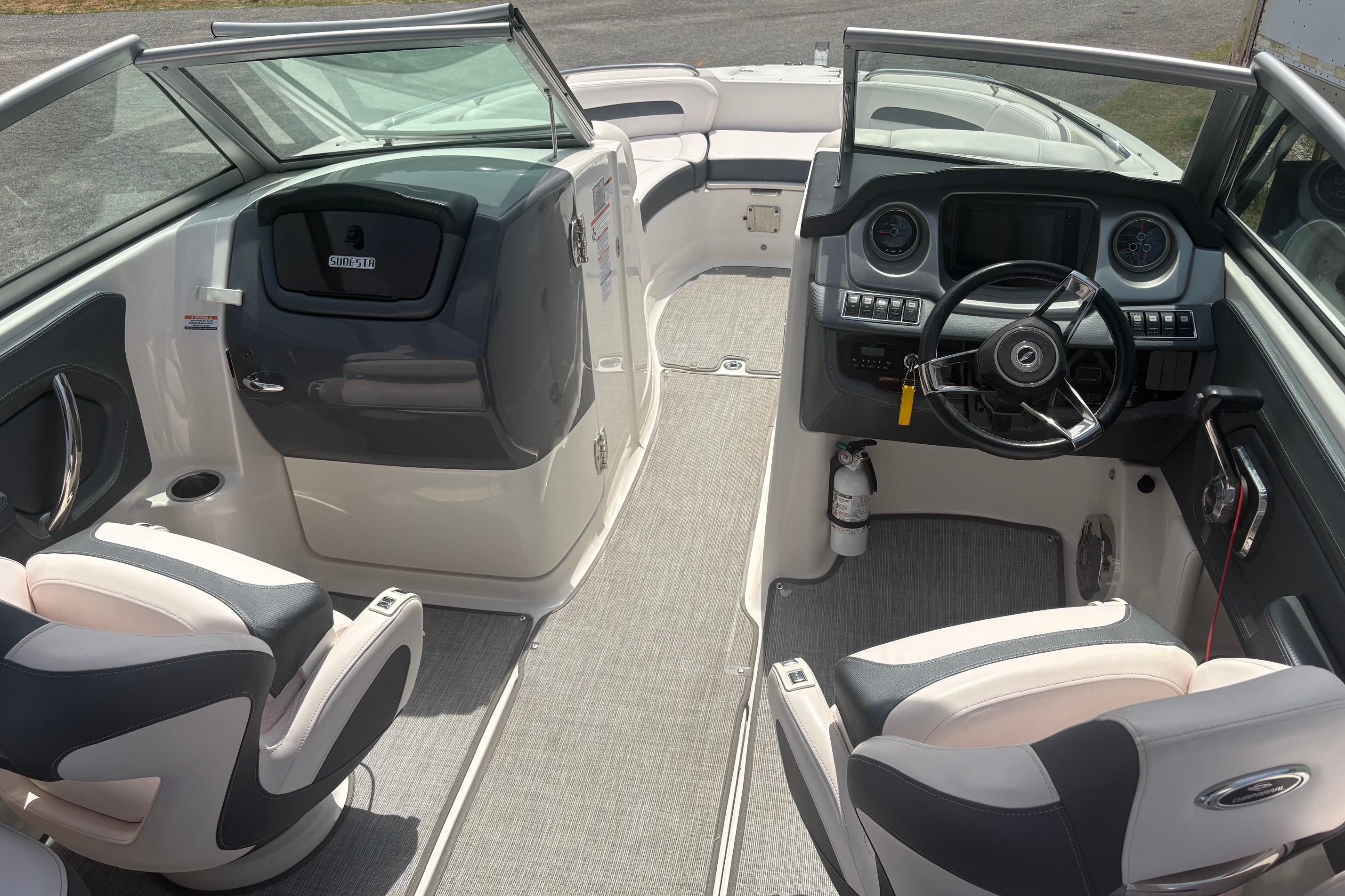 2019 Chaparral 264 Sunesta boat interior with steering wheel and seating.