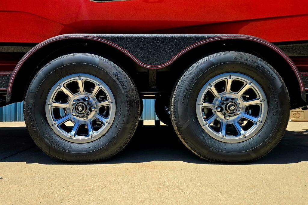 2026 Skeeter ZXE20 trailer wheels with chrome rims on a concrete surface.