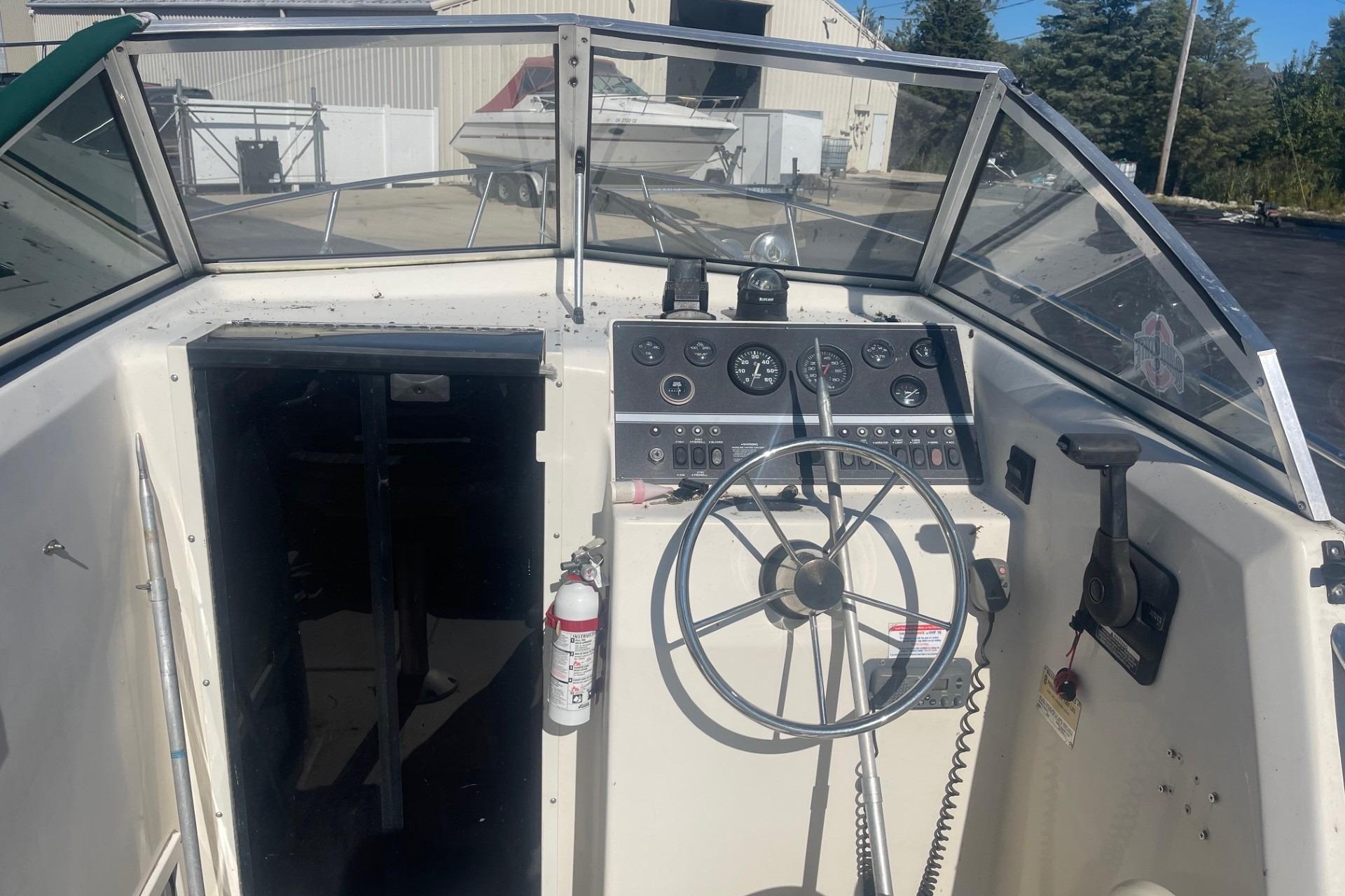 Cockpit of 2000 Seamaster 2388 WA boat with steering wheel and control panel.