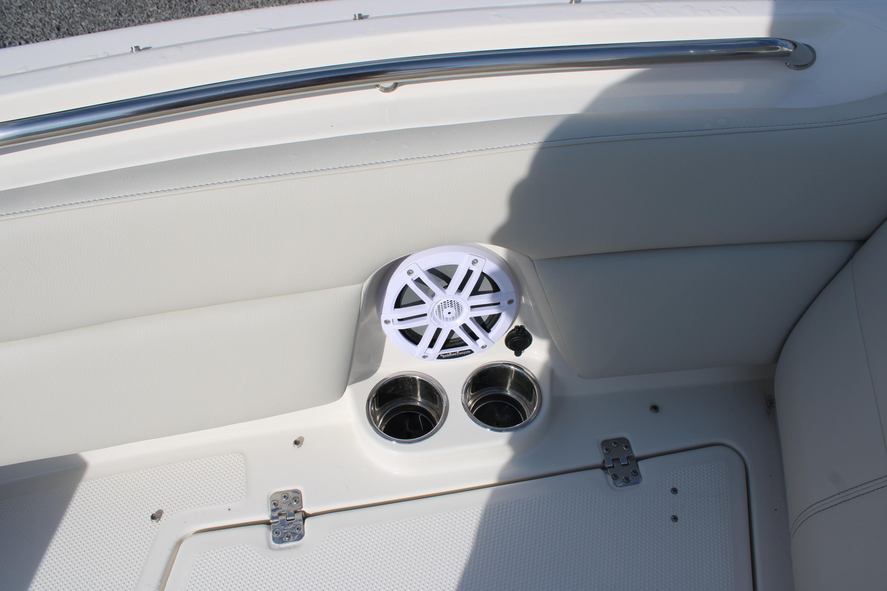 Interior of 2026 Sailfish 245 DC boat with speaker and cup holders.