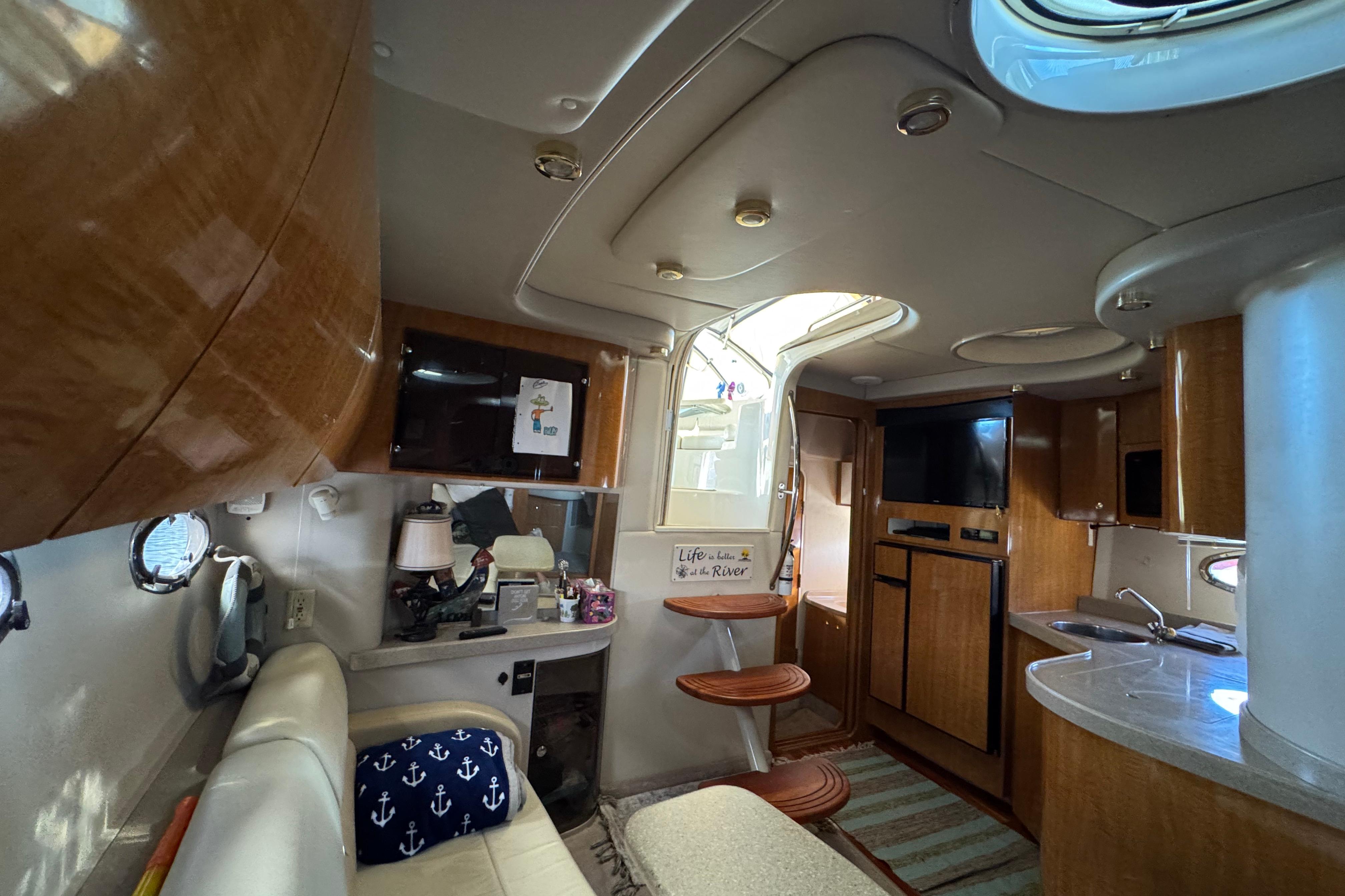 Interior of 2007 Regal Commodore 3860 yacht with modern amenities and wooden cabinetry.