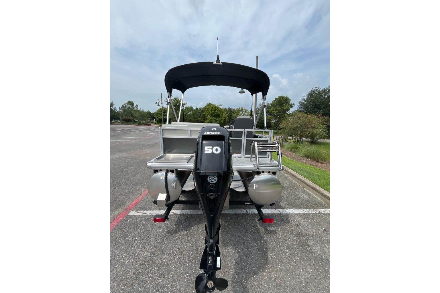 2026 Sun Tracker Bass Buggy 16 XL Select pontoon boat with Mercury 50 outboard motor.