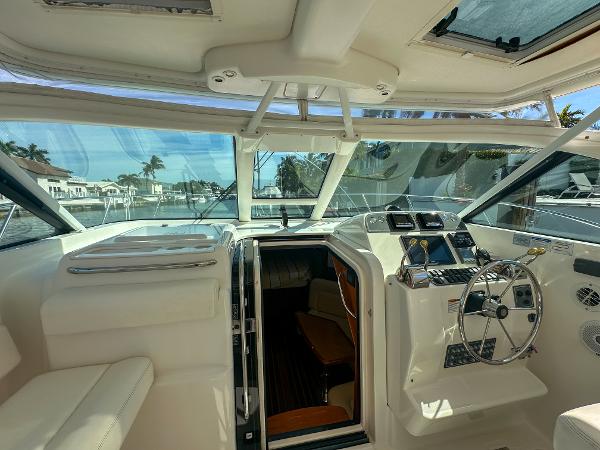 2006 Tiara Yachts 3200 Open cockpit with steering wheel and navigation controls.