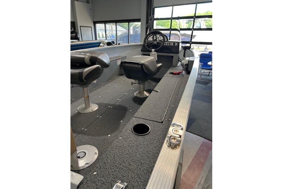 2027 Lund 1600 Fury SS boat interior with seating and steering console.