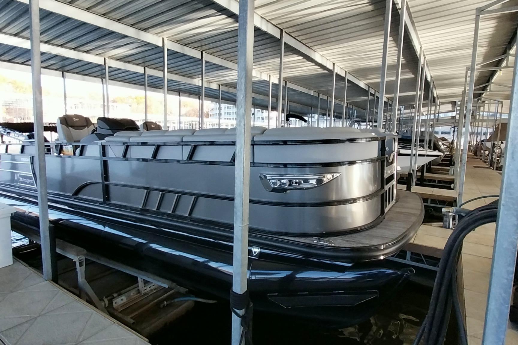 2023 Ranger 2500LS pontoon boat docked in a covered marina.