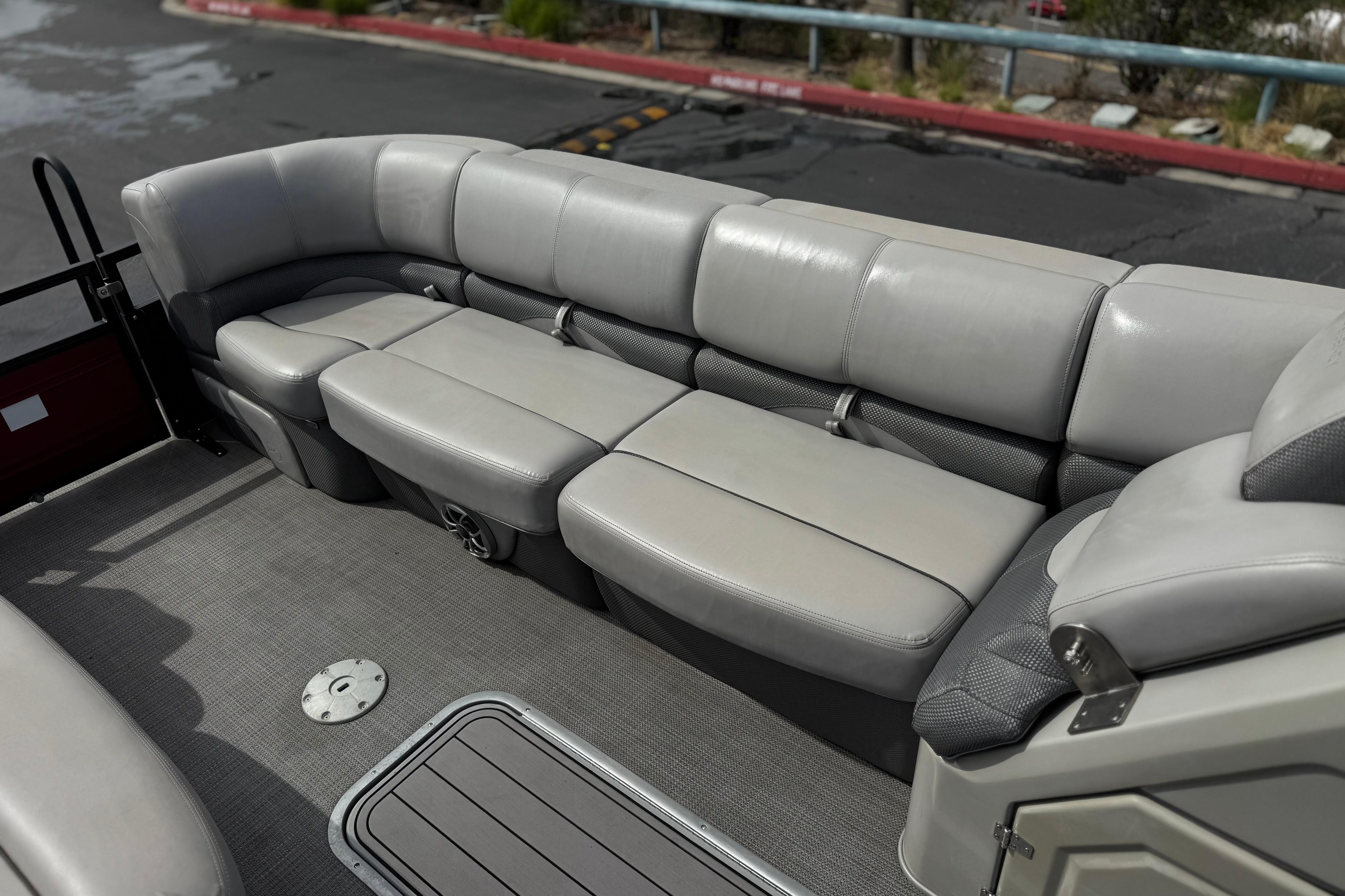 2022 Regency 250 DL3 boat interior with plush gray seating and carpeted flooring.
