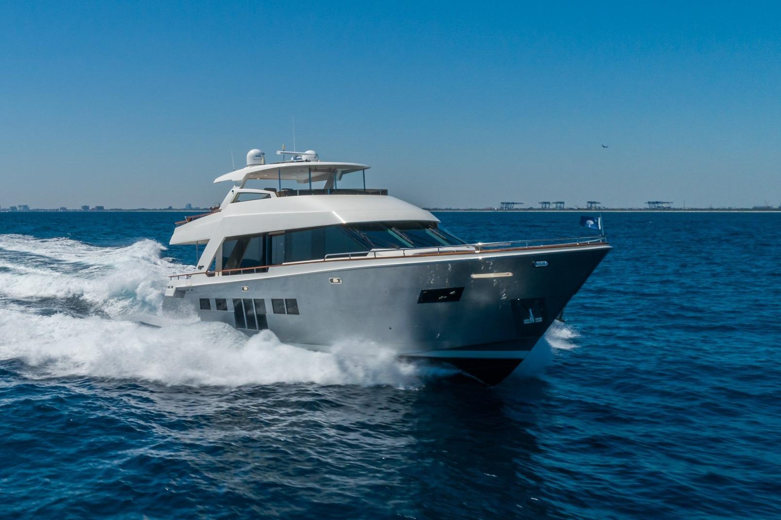 2012 Lazzara Breeze yacht cruising on open sea under clear blue sky.