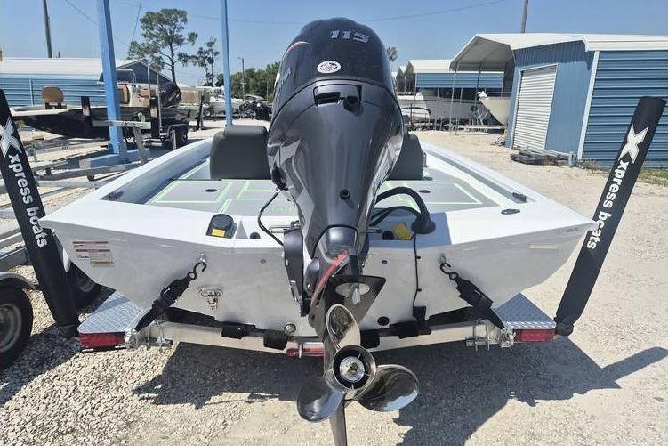2026 Xpress H18 boat with powerful outboard motor, displayed in a sunny marina setting.