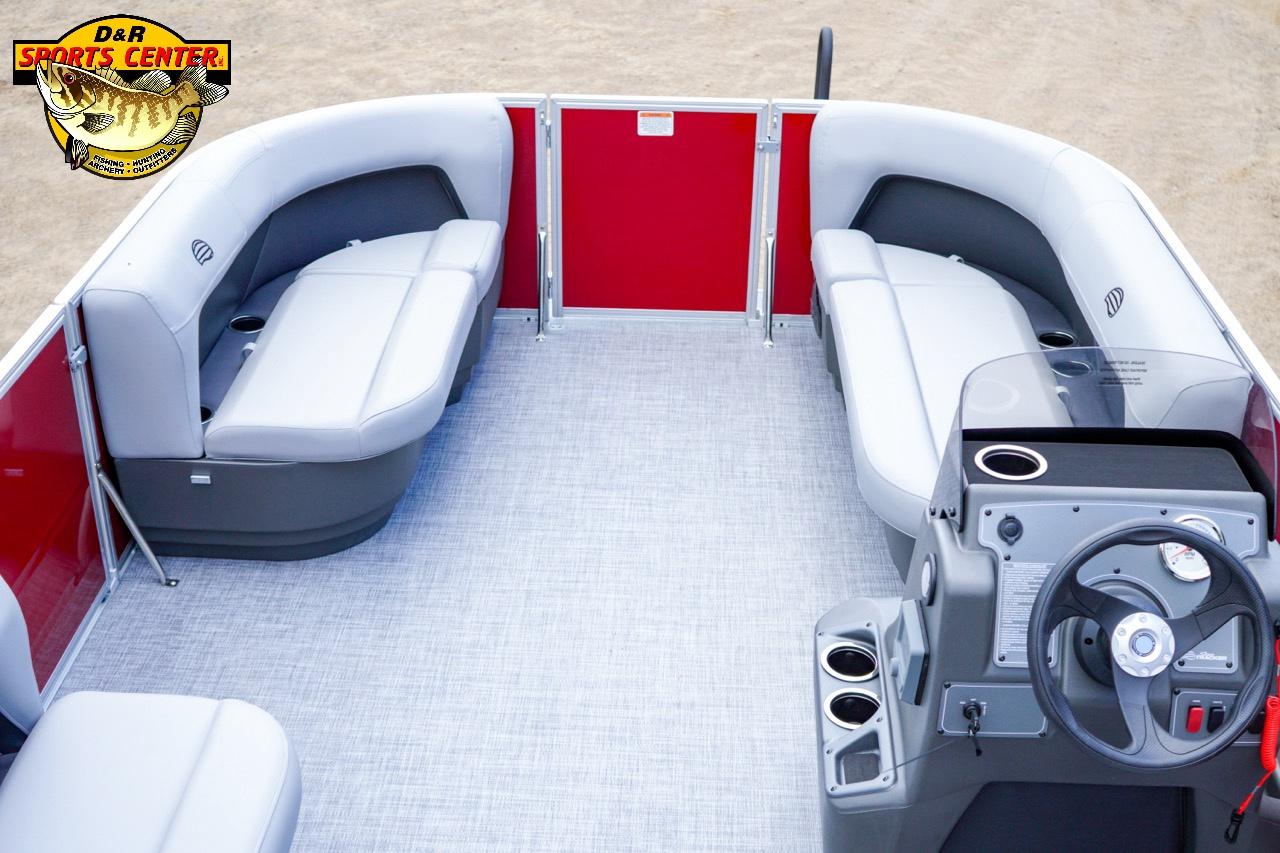 2026 Sun Tracker Party Barge 16 interior with gray seating and red accents, featuring a steering console.