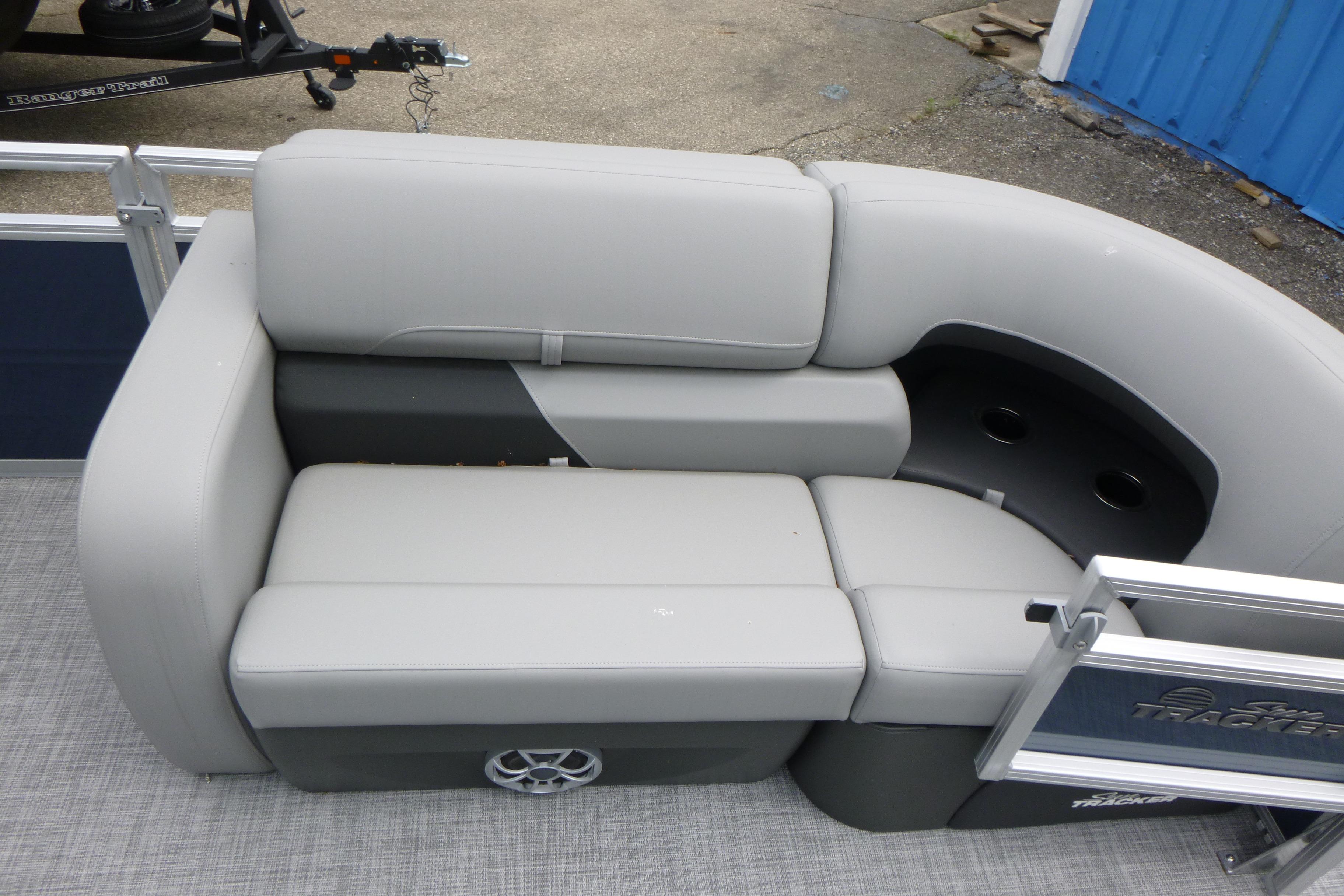 2026 Sun Tracker SportFish 22 DLX pontoon boat seating area with gray upholstery.