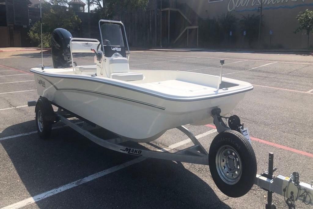2026 Mako Pro Skiff 17 CC boat on trailer in parking lot.