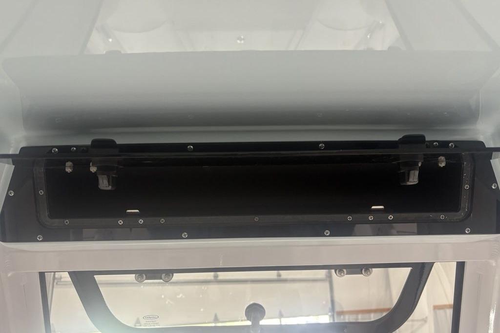 2026 Sportsman Masters 227 boat console storage compartment, open and empty.