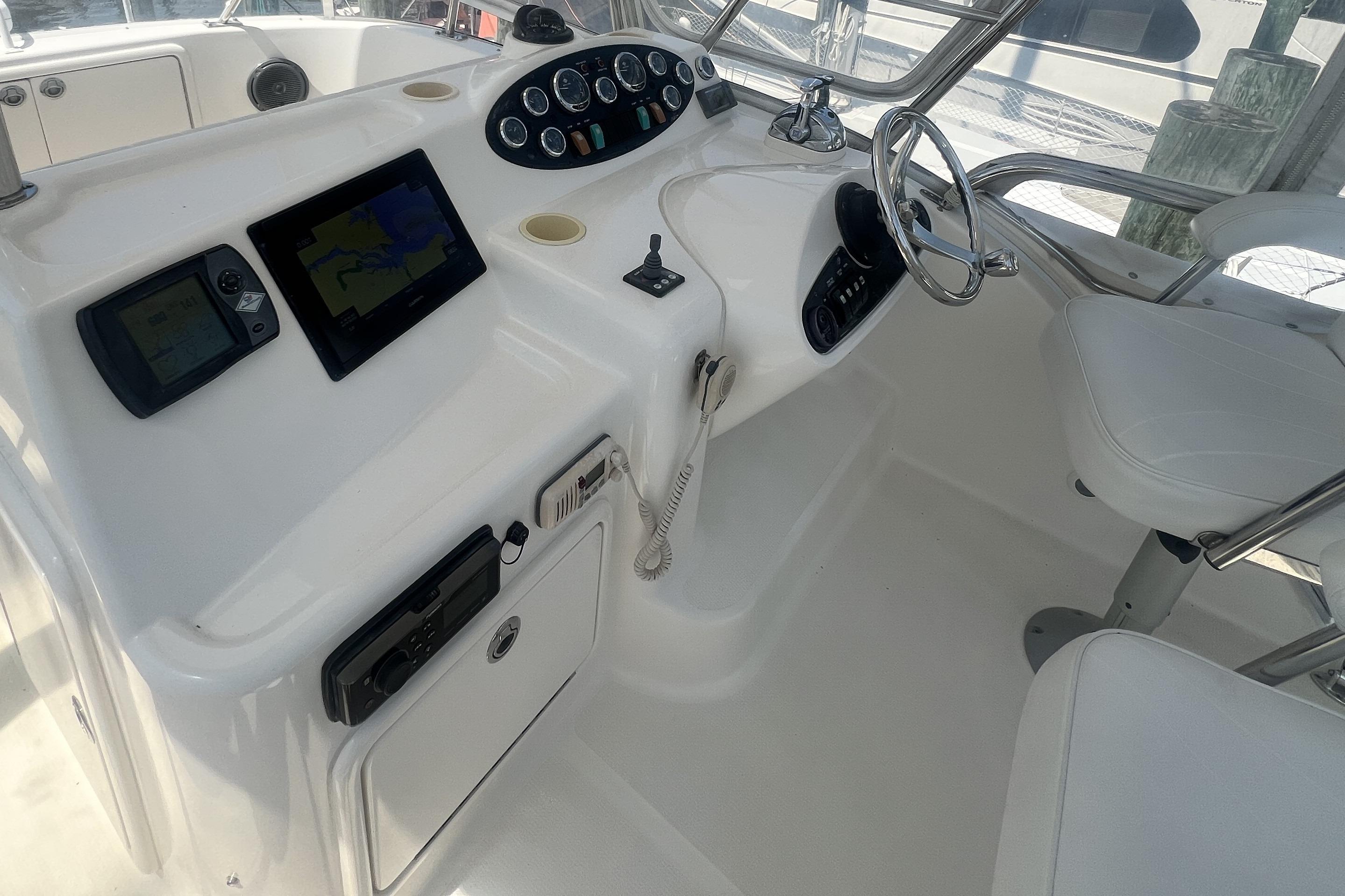 2007 Riviera 33 Flybridge helm with navigation screens and steering wheel.