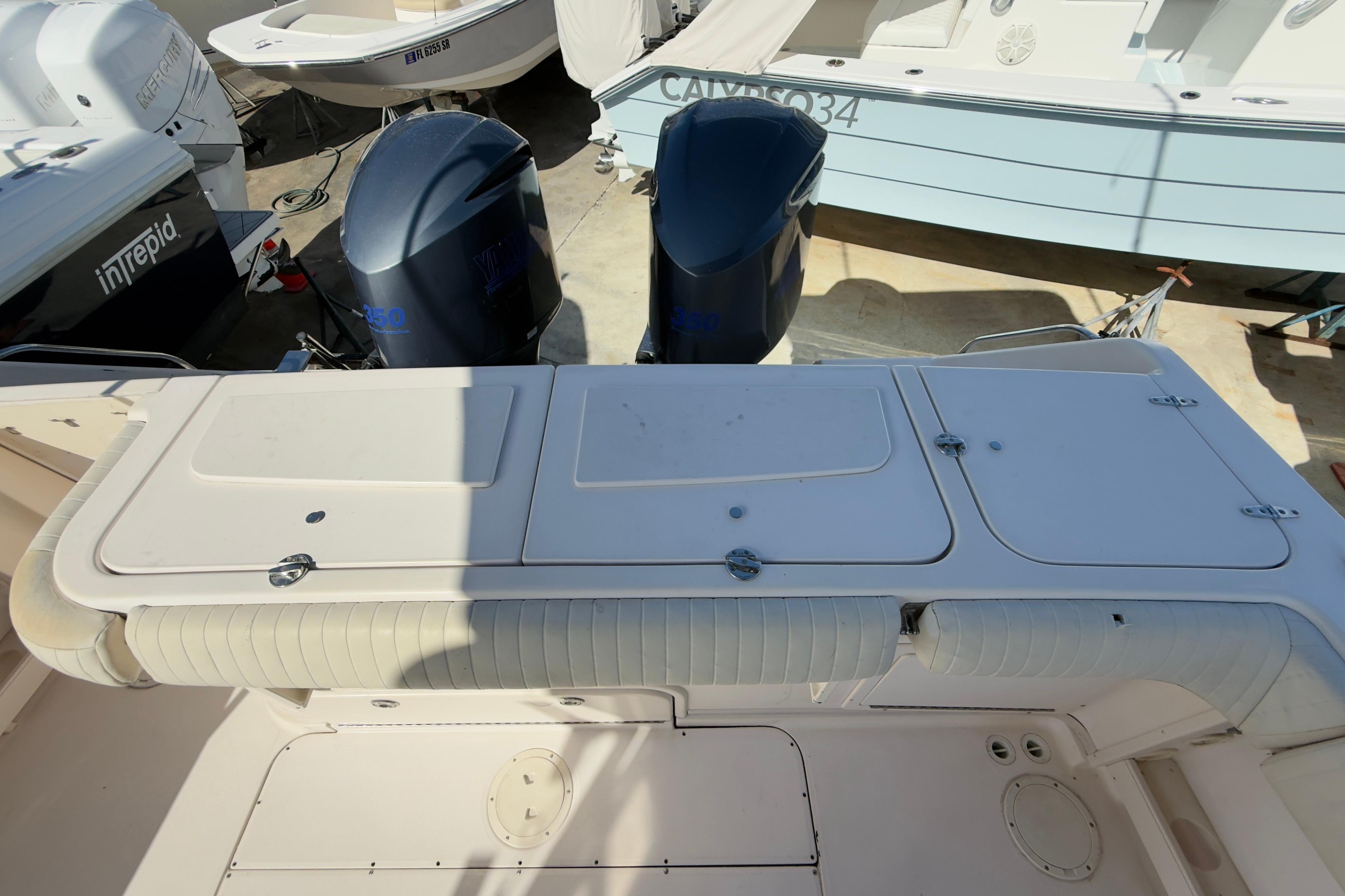 2005 Grady-White Express 330 boat with dual outboard engines in a marina setting.