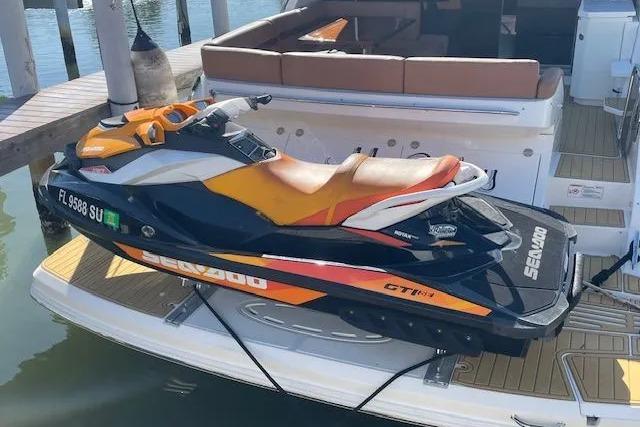 Jet ski on 2016 Sea Ray Sundancer 510 yacht deck, docked at marina.