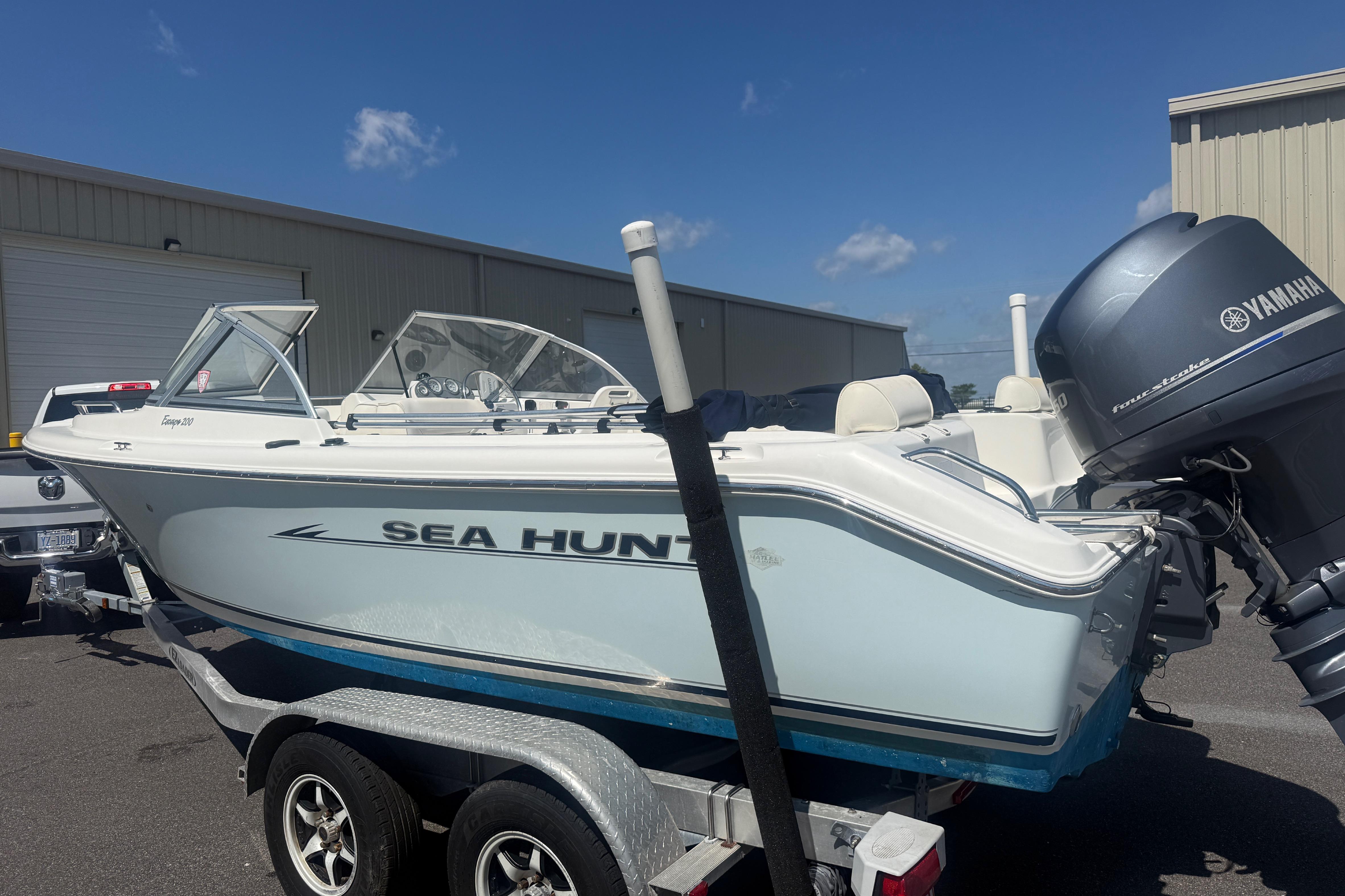 2006 Sea Hunt Escape 200 boat on trailer with Yamaha outboard motor.