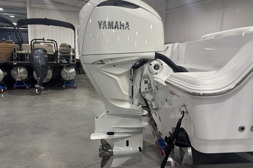2026 Sportsman Open 252 Center Console with Yamaha outboard engine in showroom.