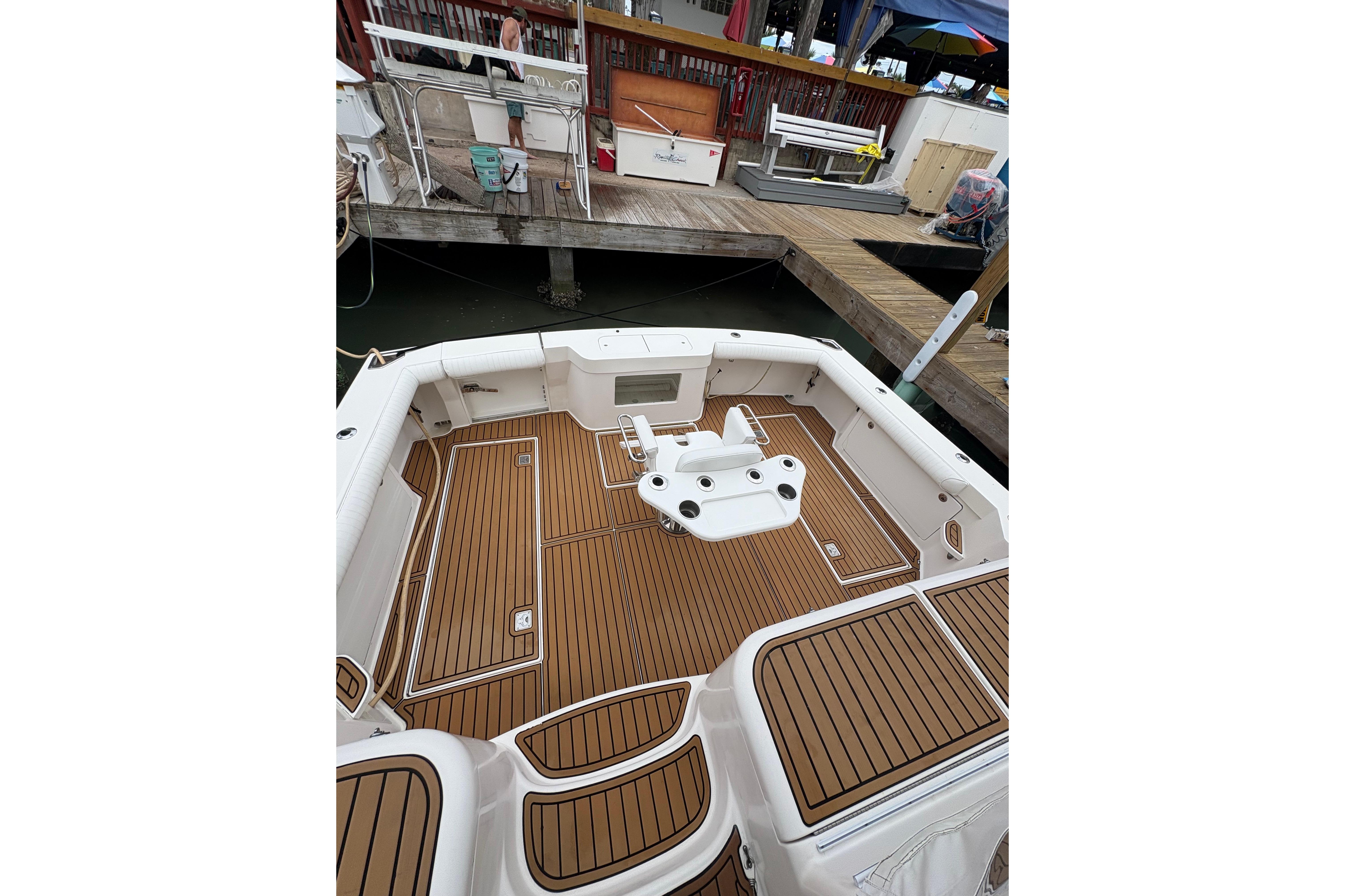 2004 Cabo 40 Hardtop Express boat with teak deck at marina.