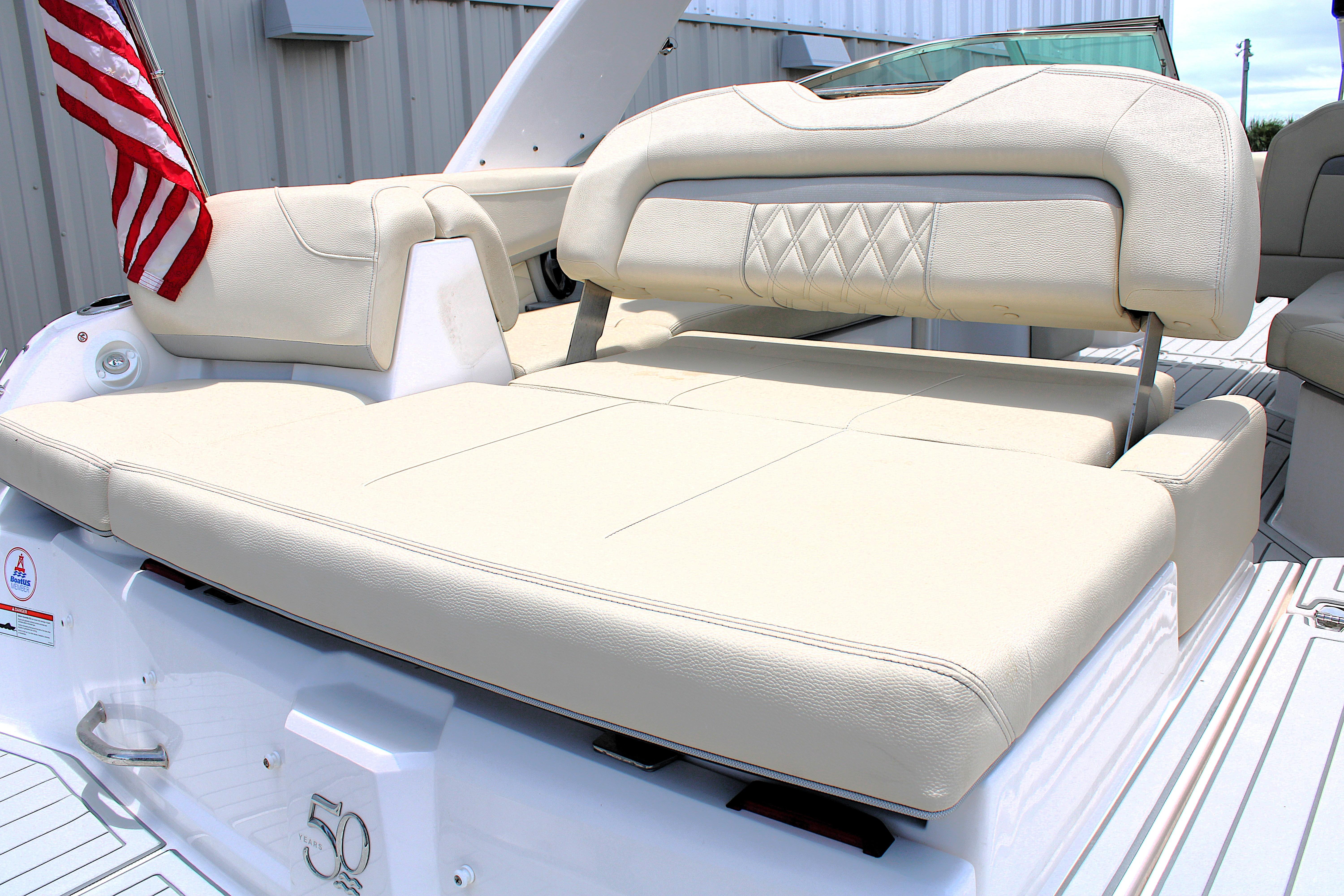 2021 Regal 26 OBX boat with beige seating and American flag.