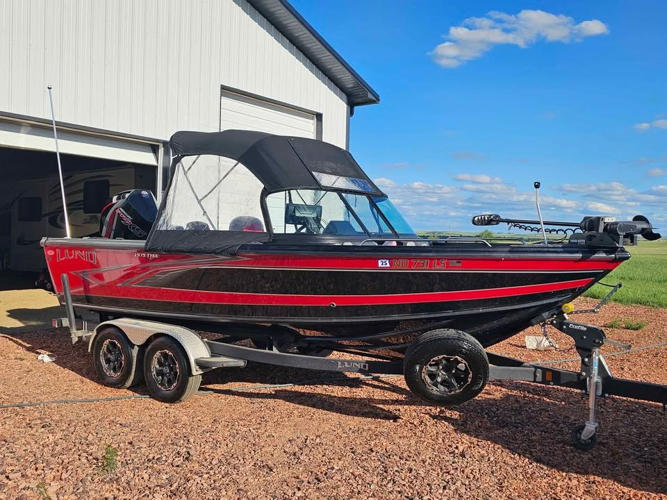 2020 Lund 1975 Tyee boat on trailer in front of garage.