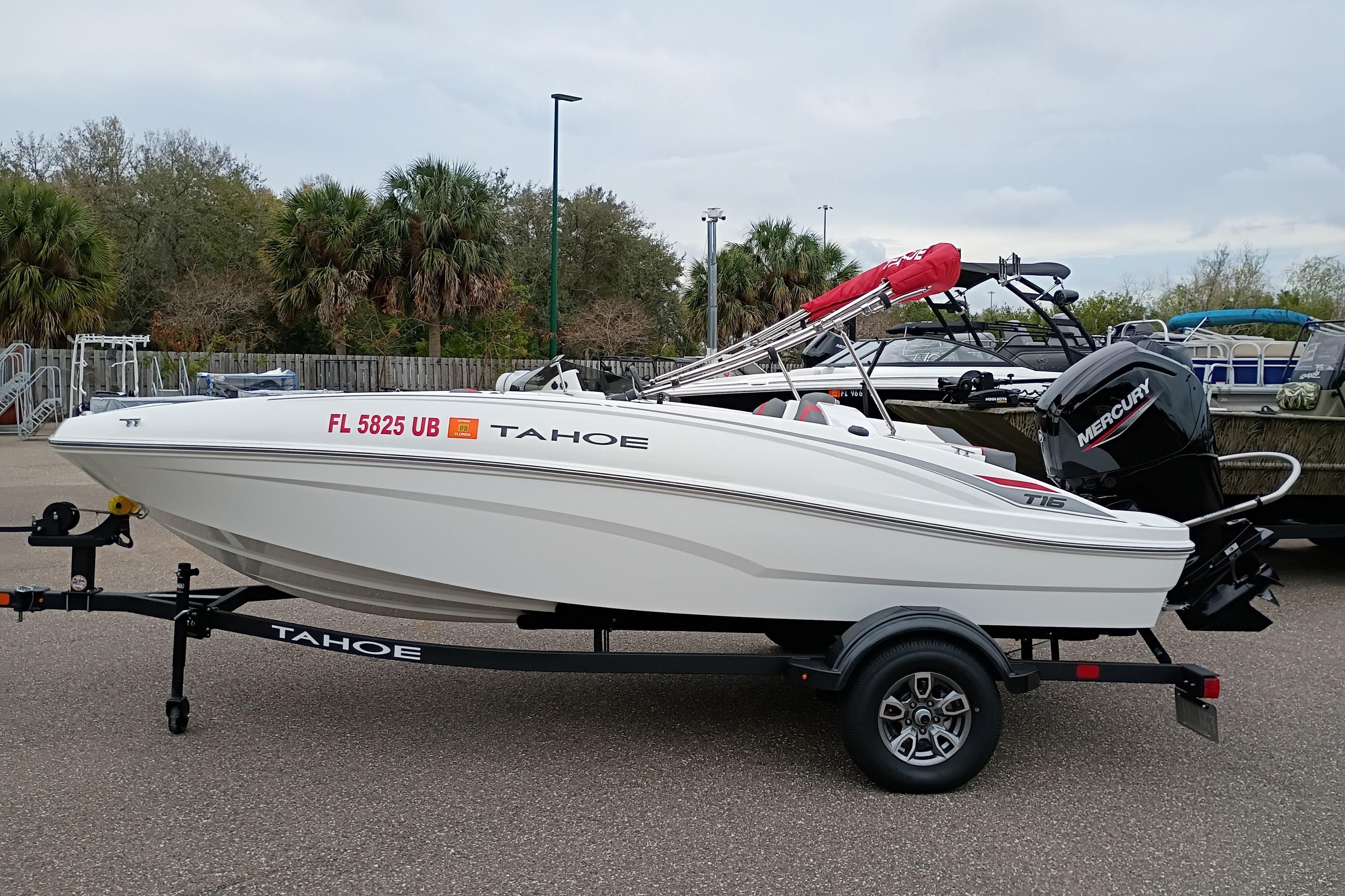 2026 Tahoe T16 boat on trailer with Mercury outboard motor, parked outdoors.