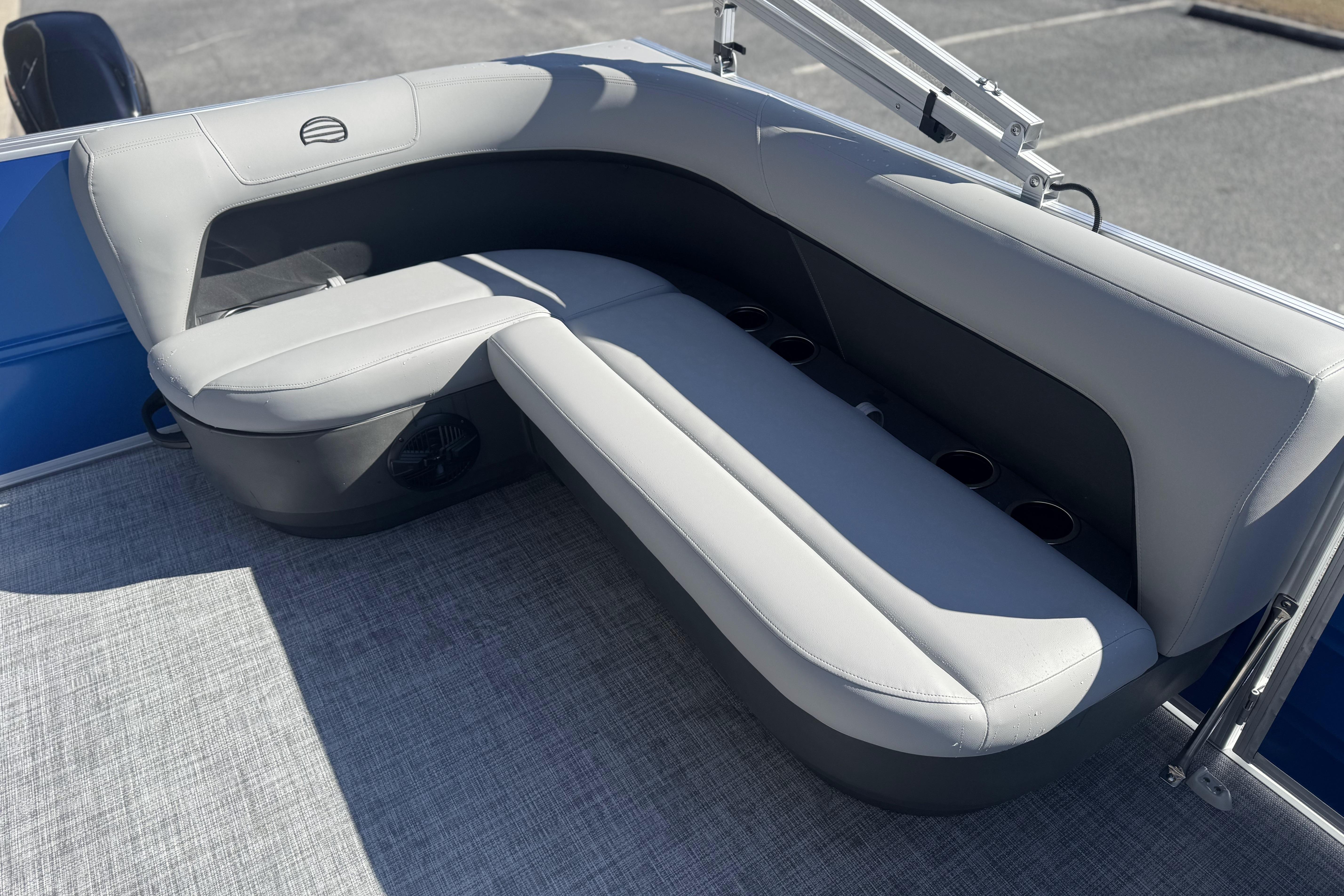 2026 Sun Tracker Party Barge 16 DLX, featuring comfortable gray seating and cup holders.