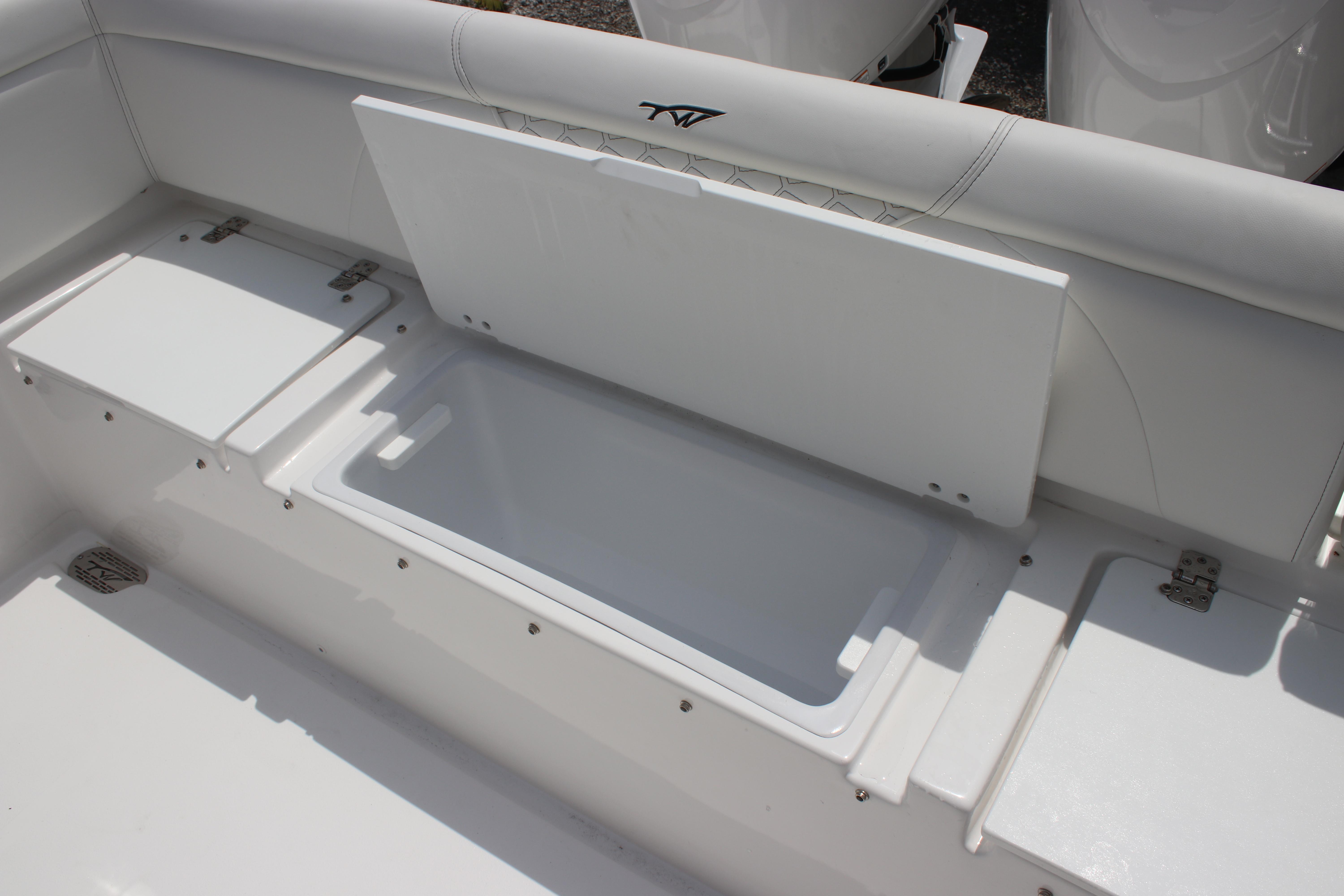 2026 Tidewater 272 LXF boat seating with storage compartment open.