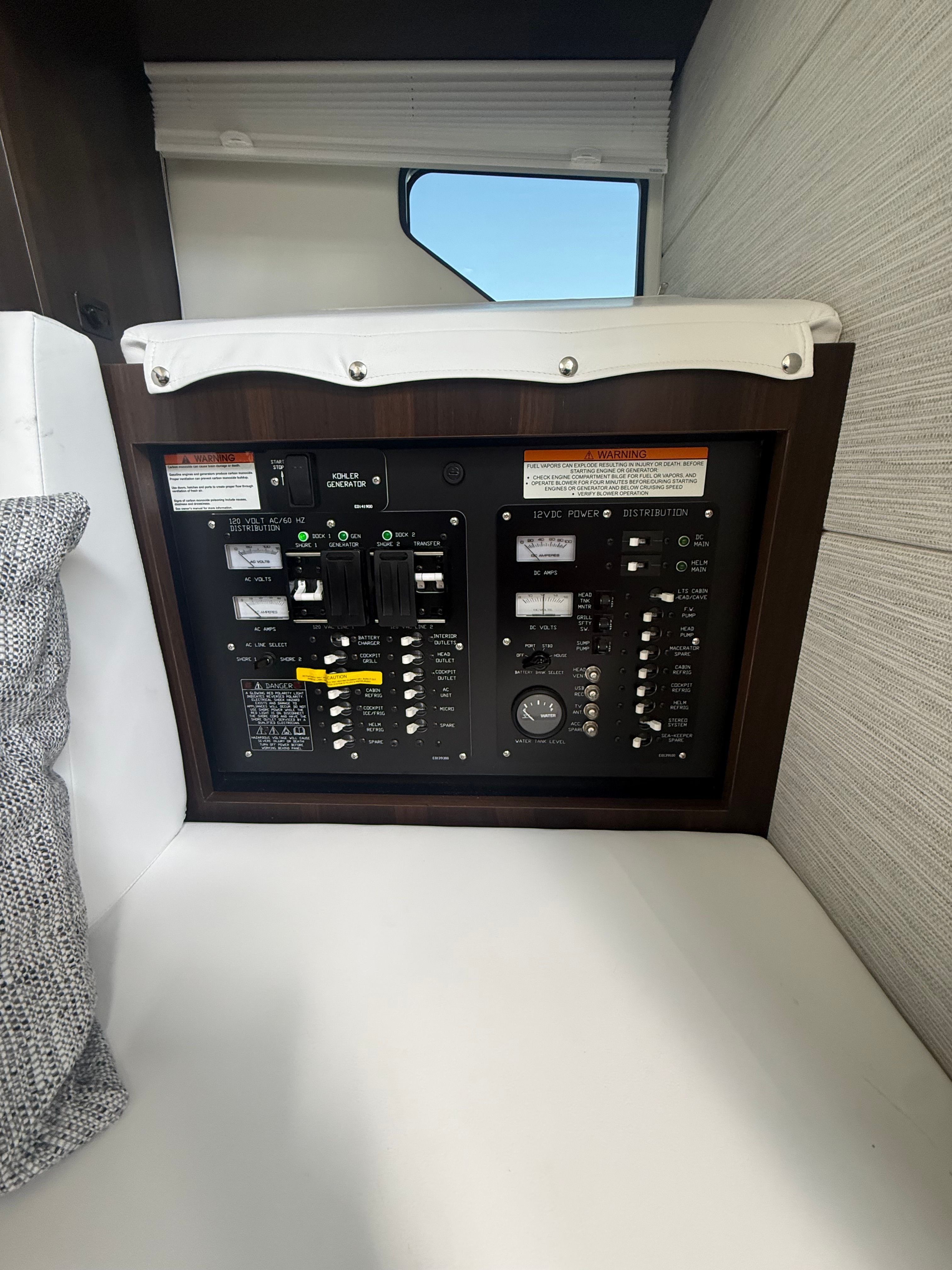 Electrical control panel in a yacht with various switches and indicators.