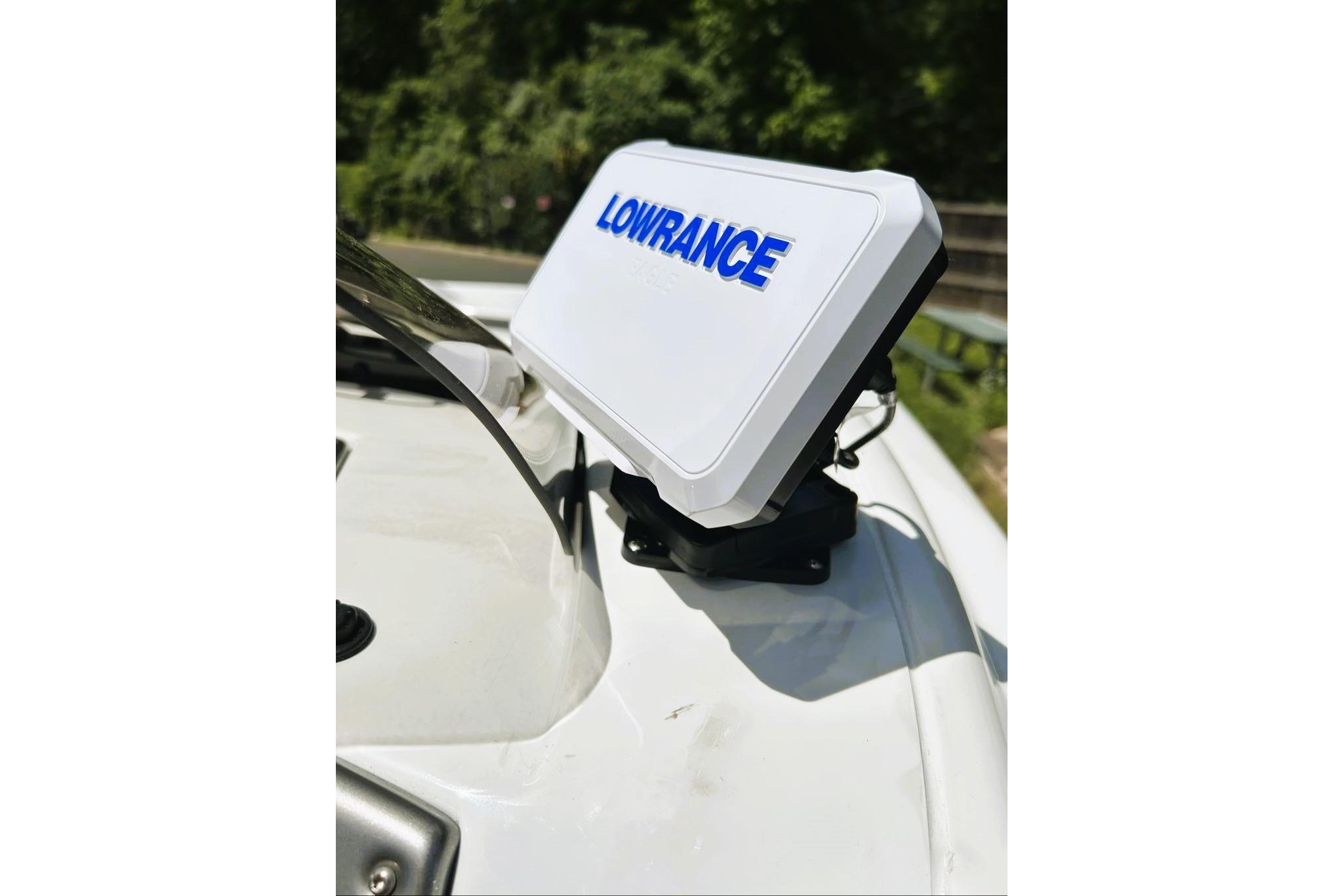Lowrance device on 2026 Tahoe 2150 boat, mounted on white surface.