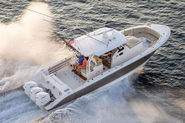 Manufacturer Provided Image: 2018 Pursuit S 368 Sport boat cruising on water with triple outboard engines.