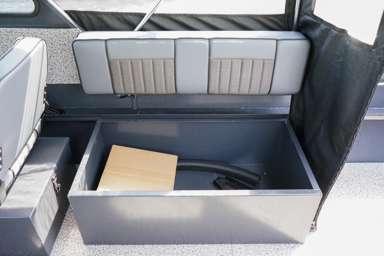 2026 Alumaweld X202 Stryker boat interior storage compartment with box and hose.
