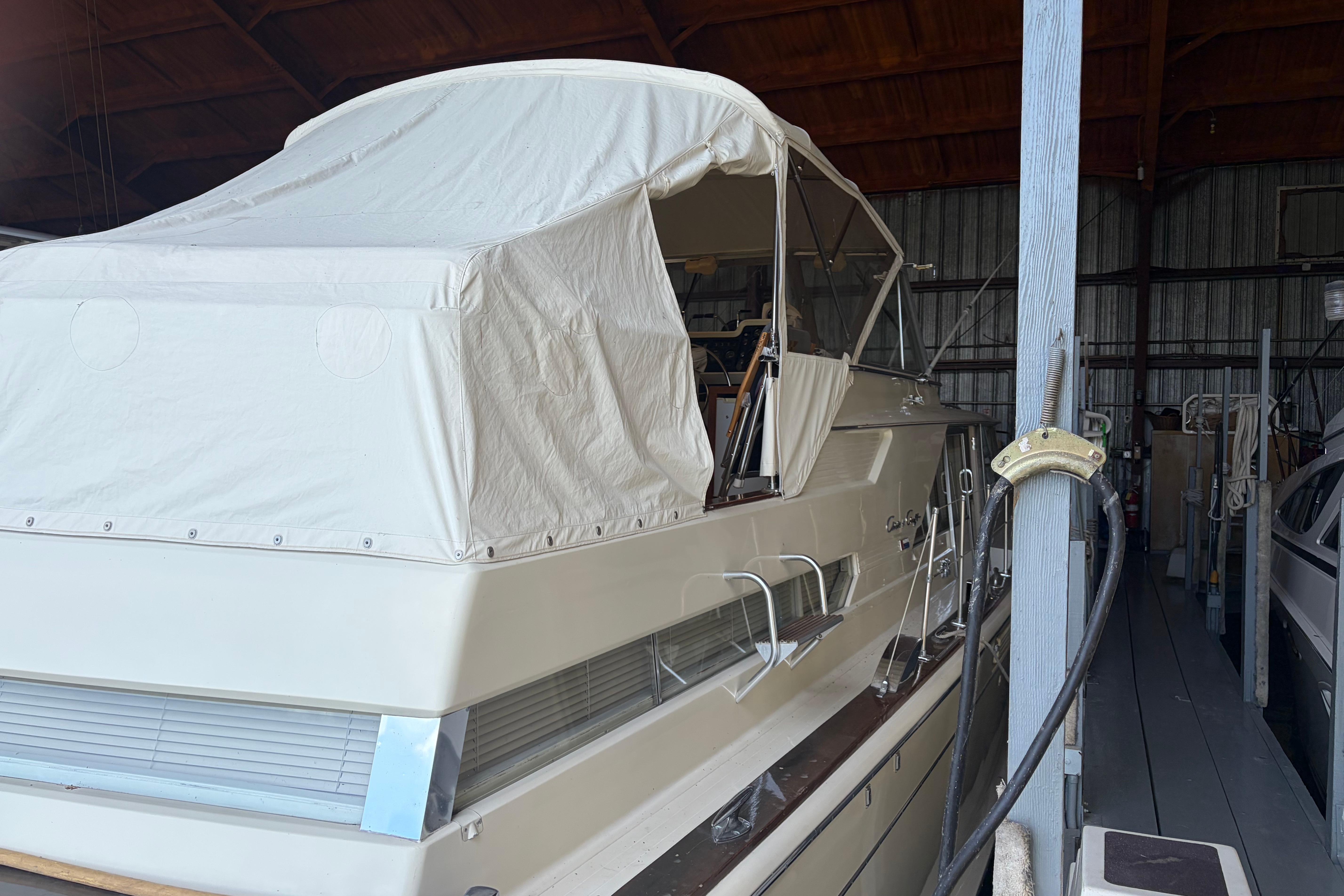1971 Chris-Craft 42 Commander yacht in storage with protective cover.