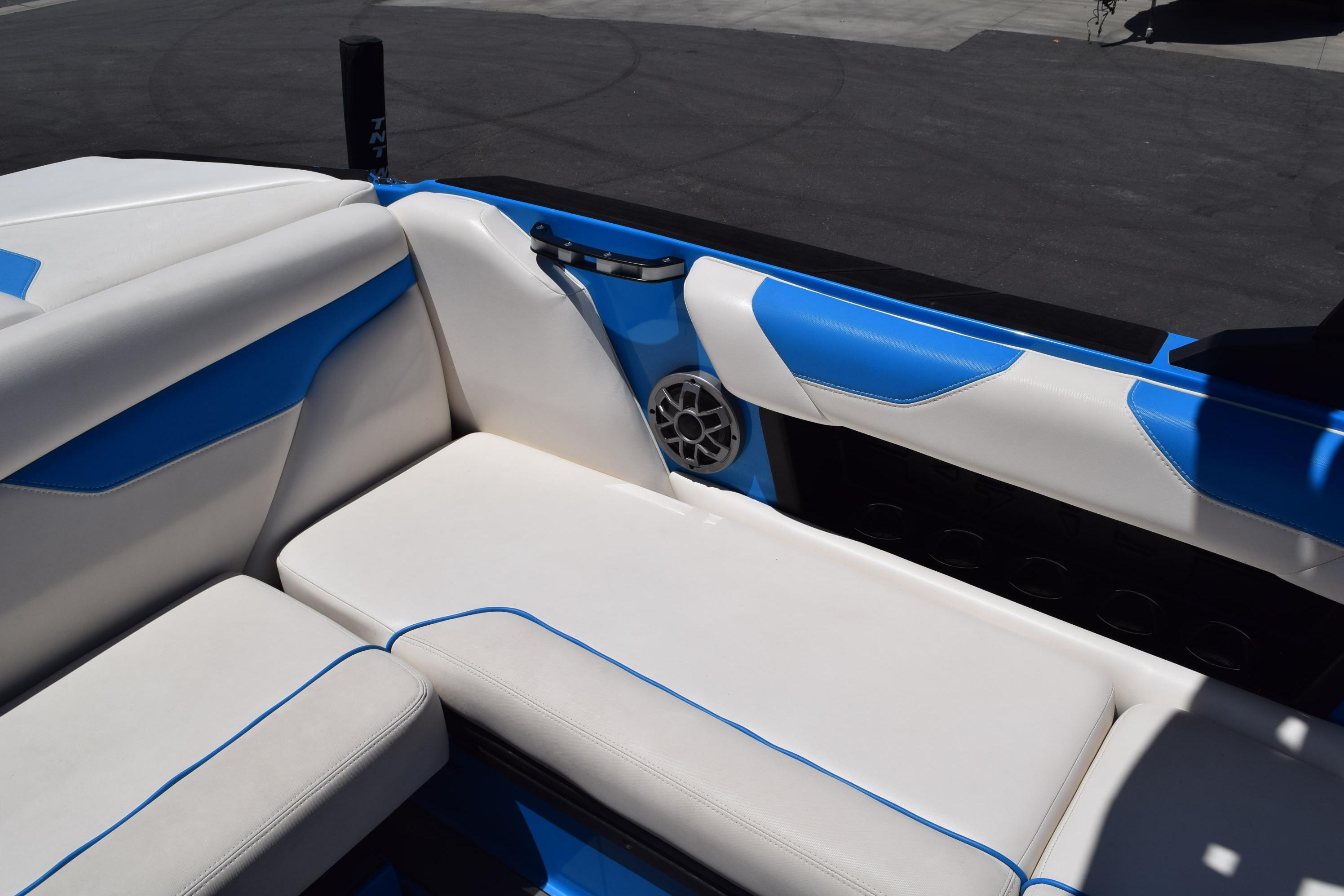 2019 Axis A22 boat interior with white and blue seating, speaker, and cup holder.