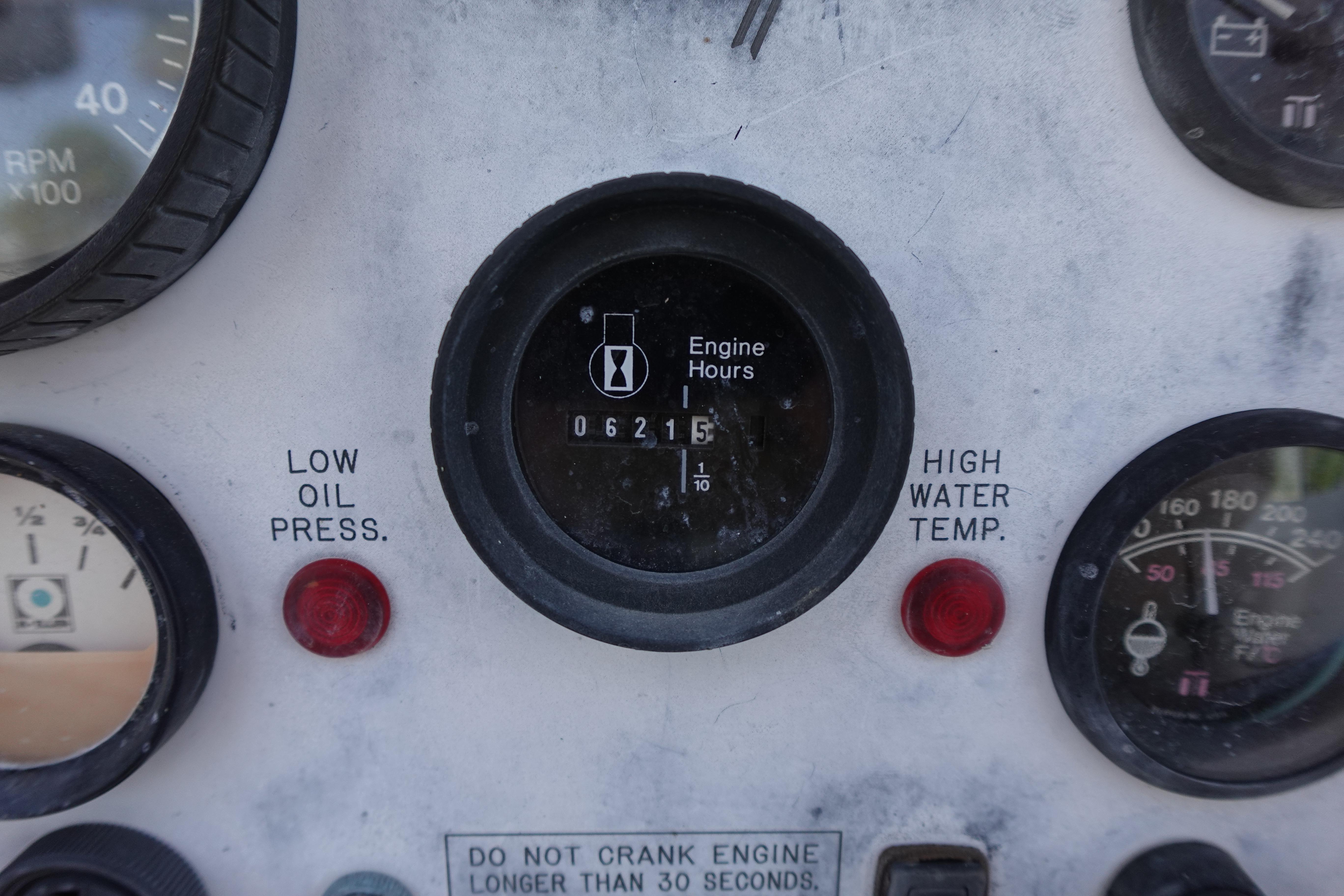 Close-up of a 1997 Catalina 28 engine panel with gauges and warning lights.