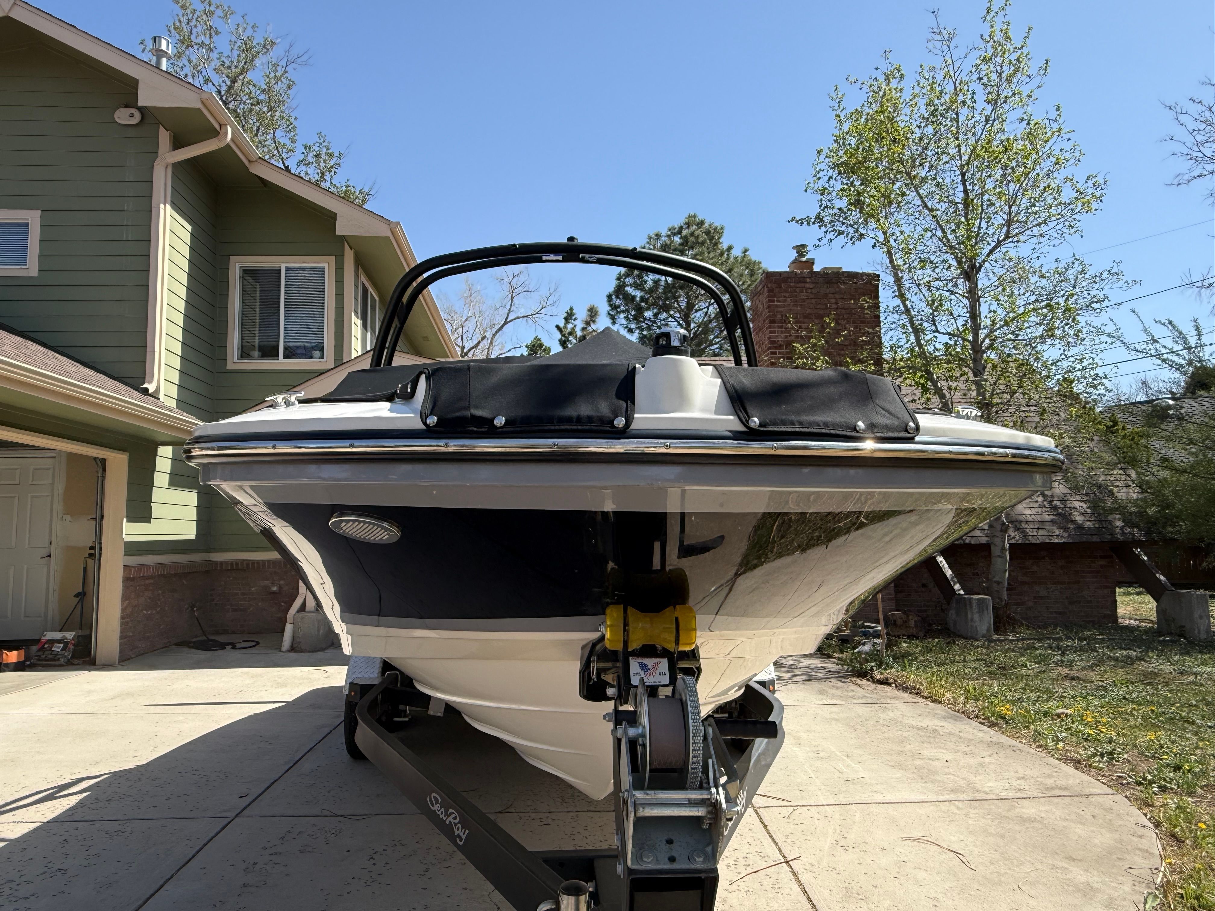 2022 Sea Ray SPX 210 boat on trailer in front of house.