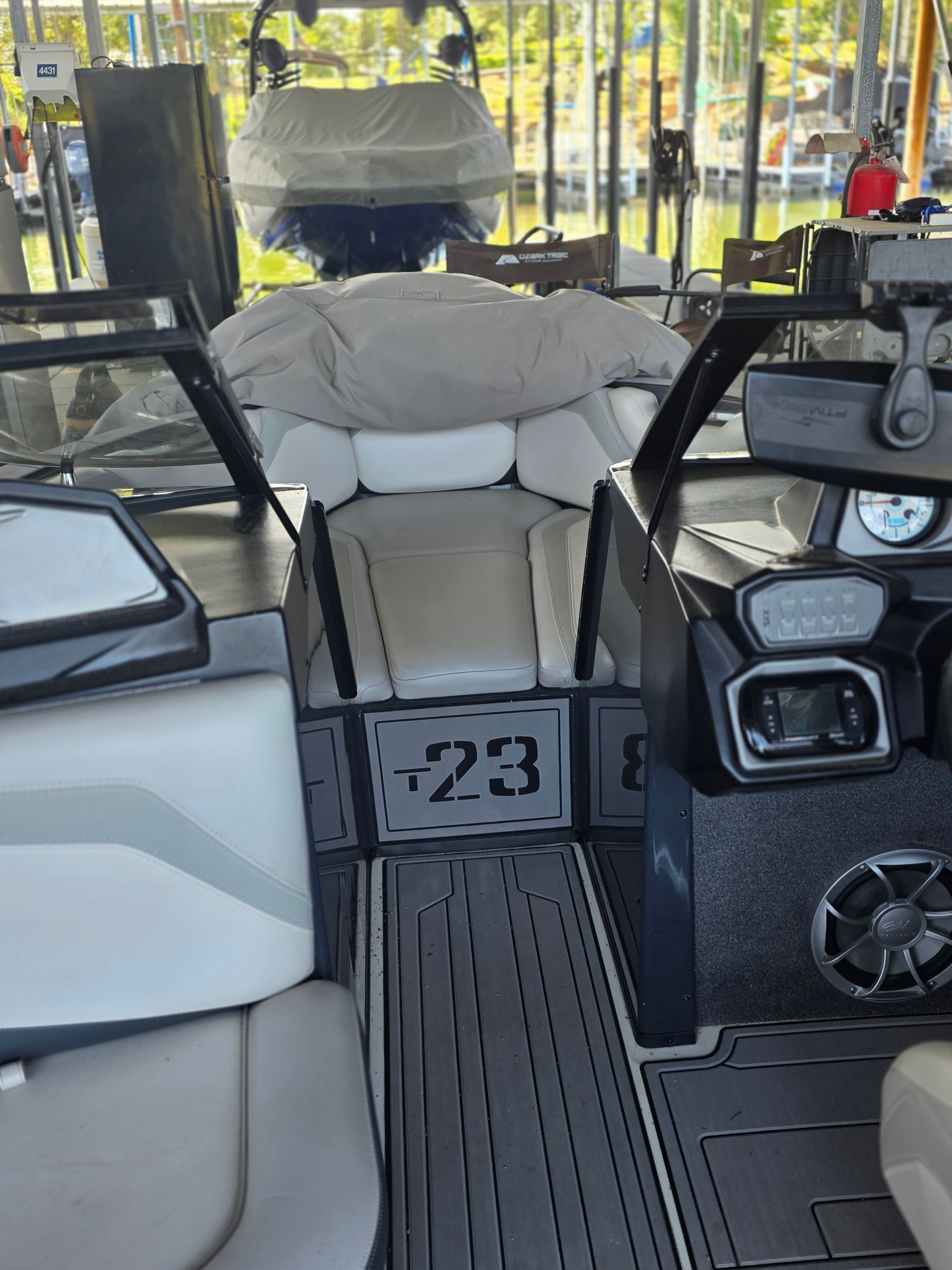 The image shows the cockpit of a 2017 Axis T23 boat with gray upholstery.
