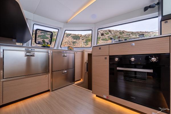 Modern kitchen interior of 2025 Nautitech 44 Open yacht with sleek appliances and panoramic windows.